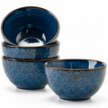 Set of four embossed blue porcelain bowls on a white background