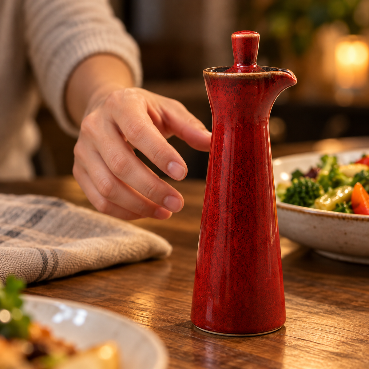 Red ceramic seasoning bottle on a dining table