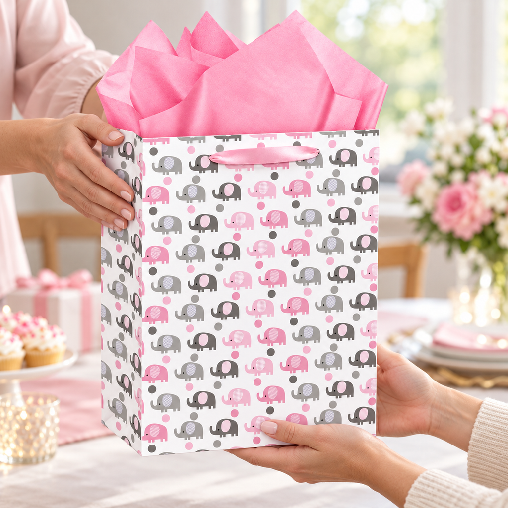 Pink and Grey Elephant Gift Bag with Card being handed to another adult