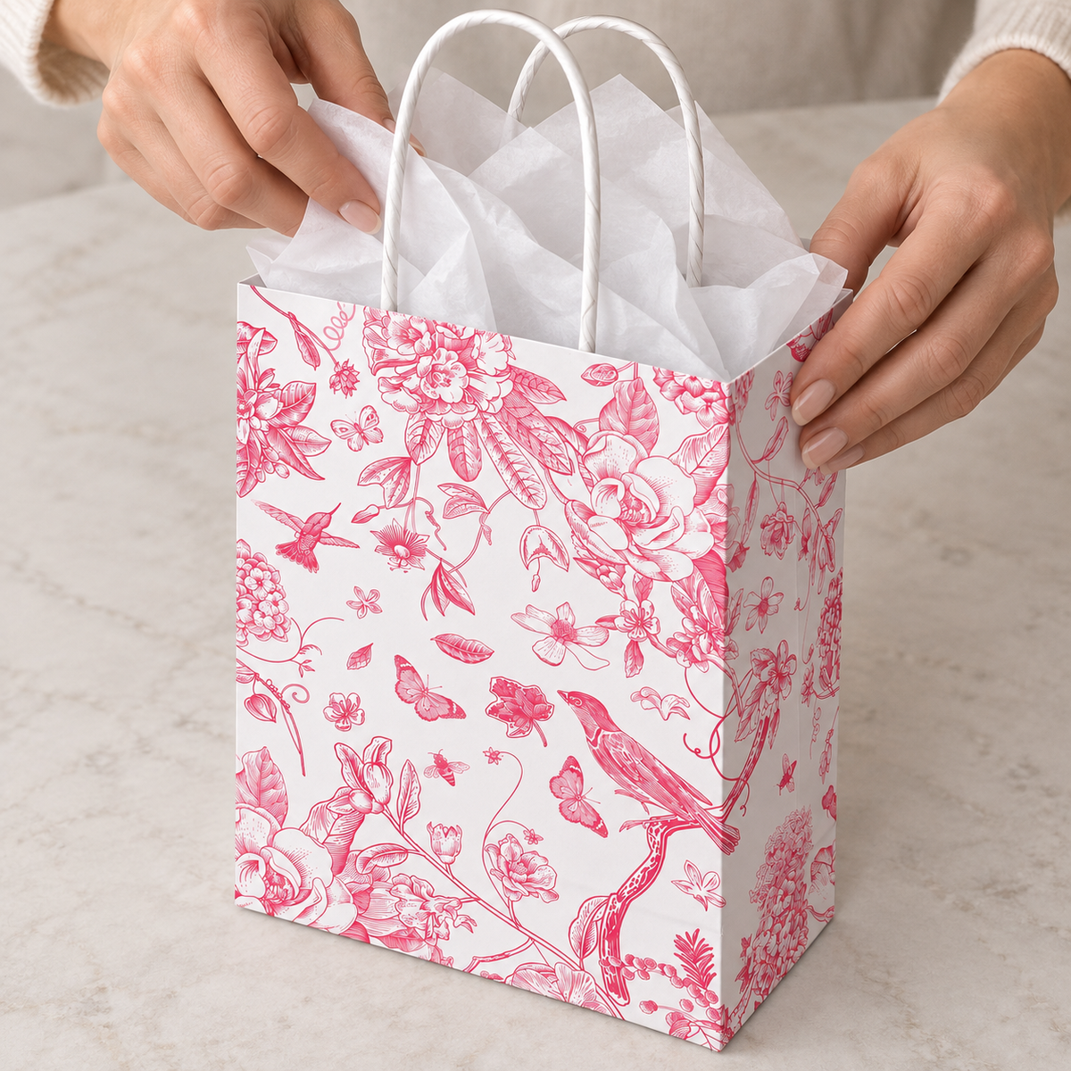 Pink Floral and Bird Paper Gift Bags, 16 pc — high-angle tissue packing