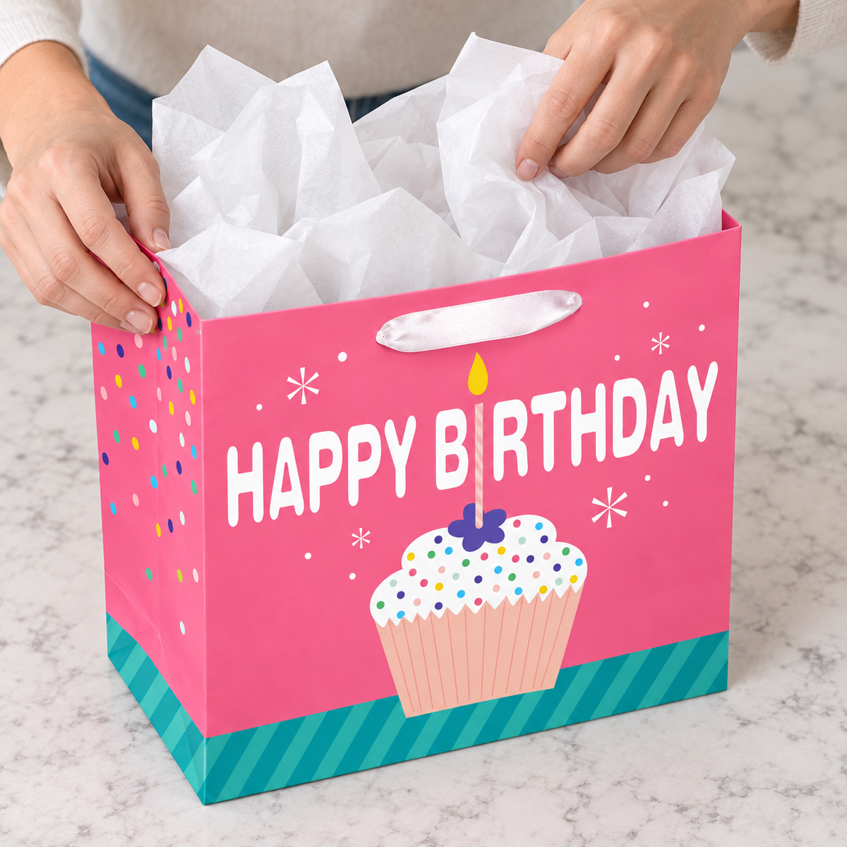 Pink Cupcake Birthday Gift Bag with Card and Tissue with tissue being placed into the opening