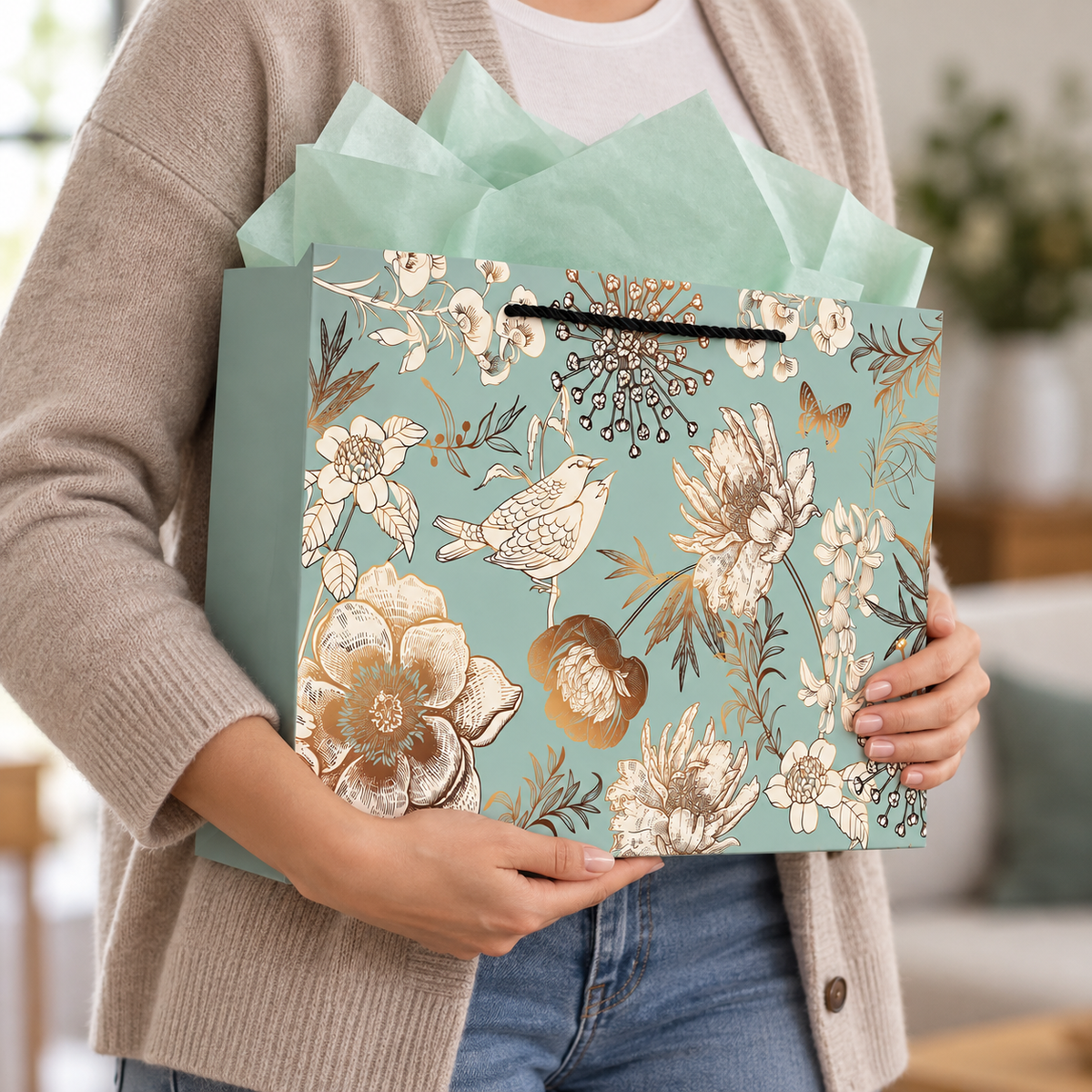 Green Floral and Bird Gift Bag with Tissue and Card carried by an adult