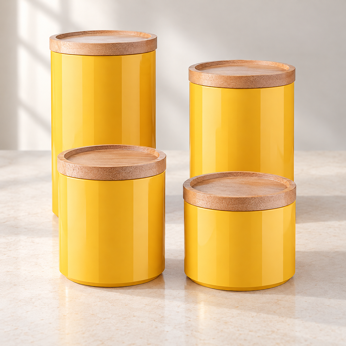 Four closed yellow canisters arranged as two taller and two shorter pairs on a styled countertop.