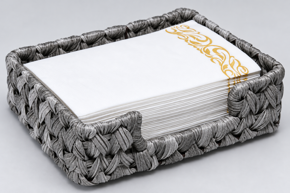 Close-up of the gray woven napkin holder showing the ribbon weave and wrapped rim. Napkins and styling accessories are not included.