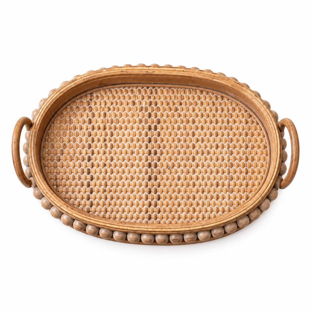Overhead view of one rattan and wood serving tray with woven base and beaded rim on white.