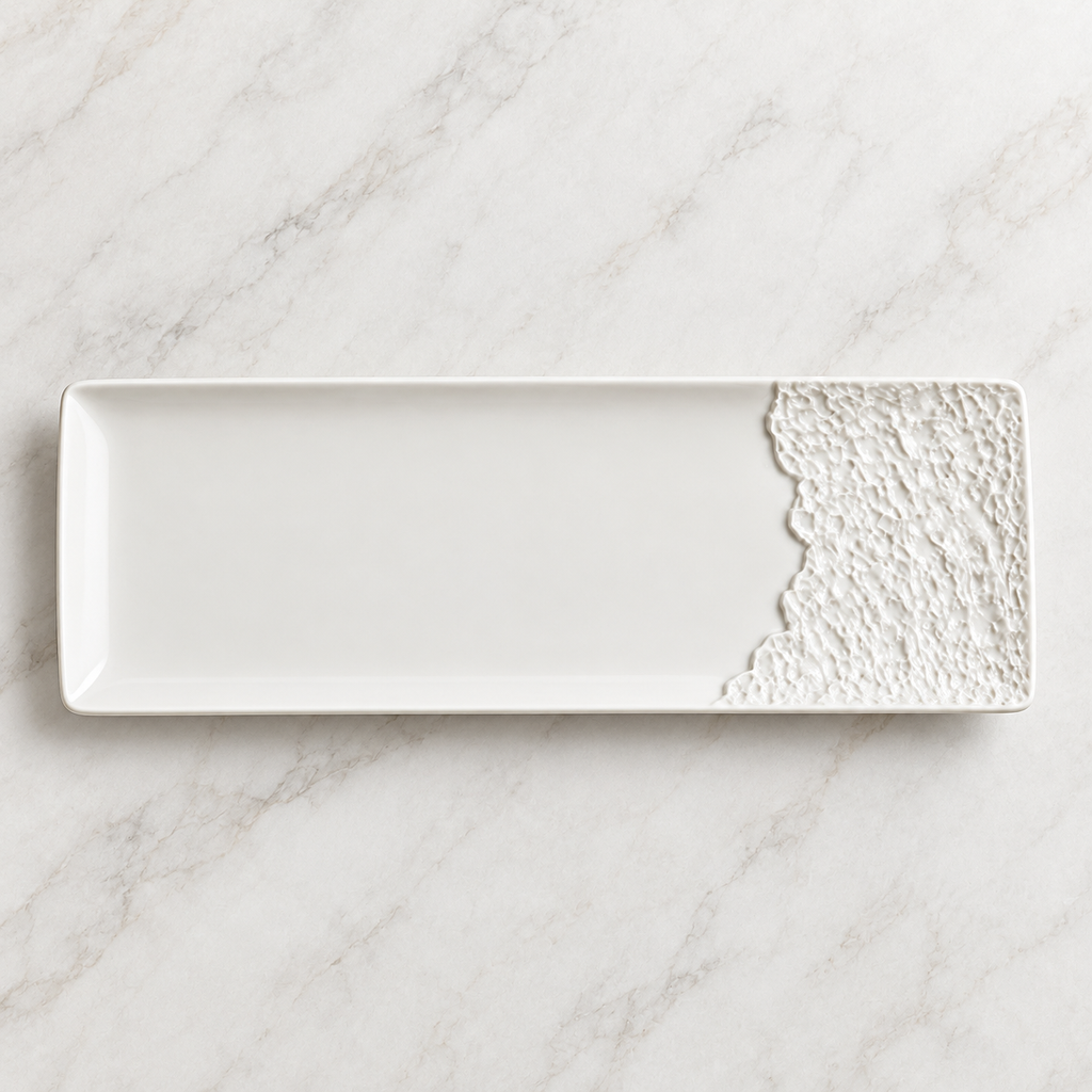 Overhead view of an empty rectangular porcelain platter with one rock-texture end.