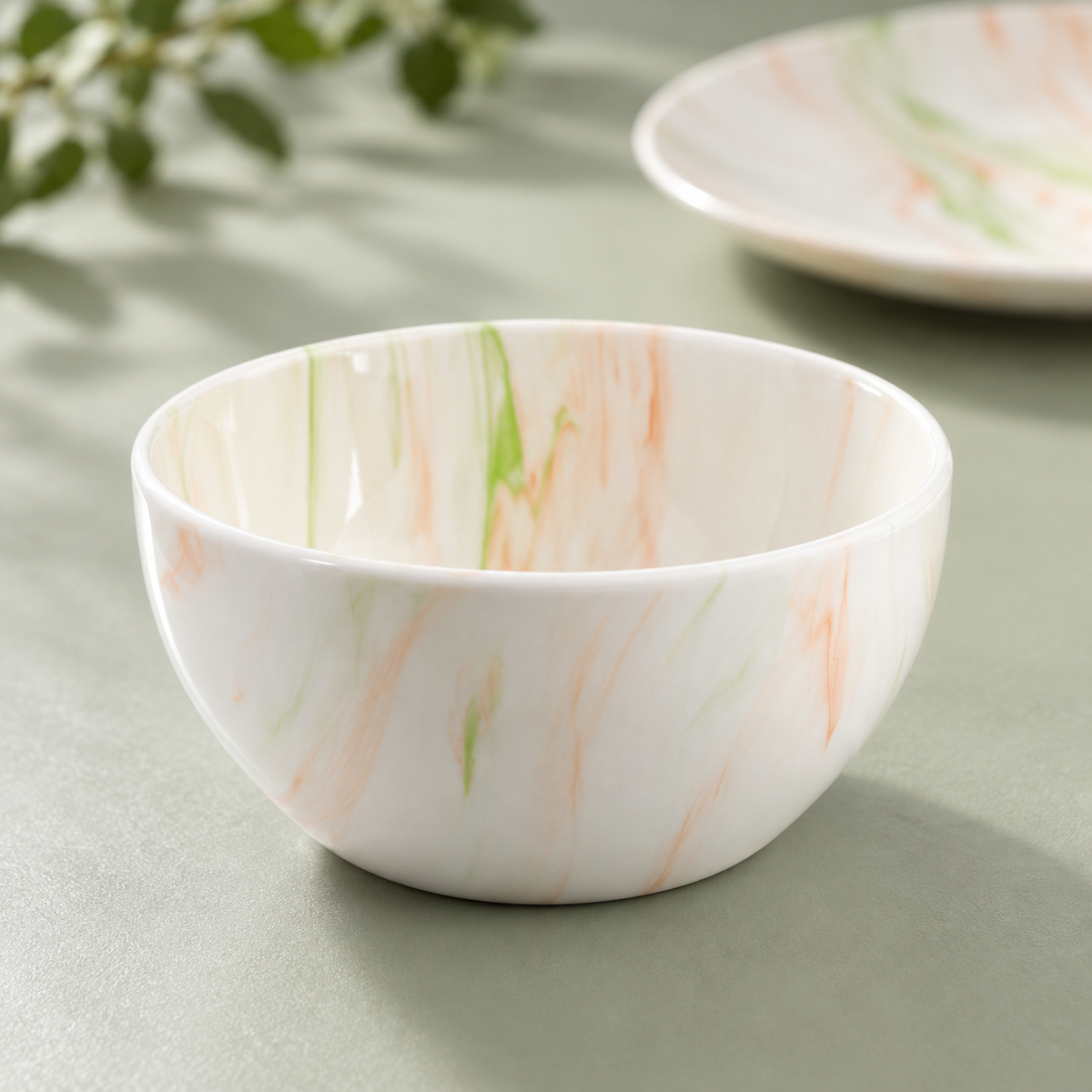 Close view of the orange and green marble-pattern bowl