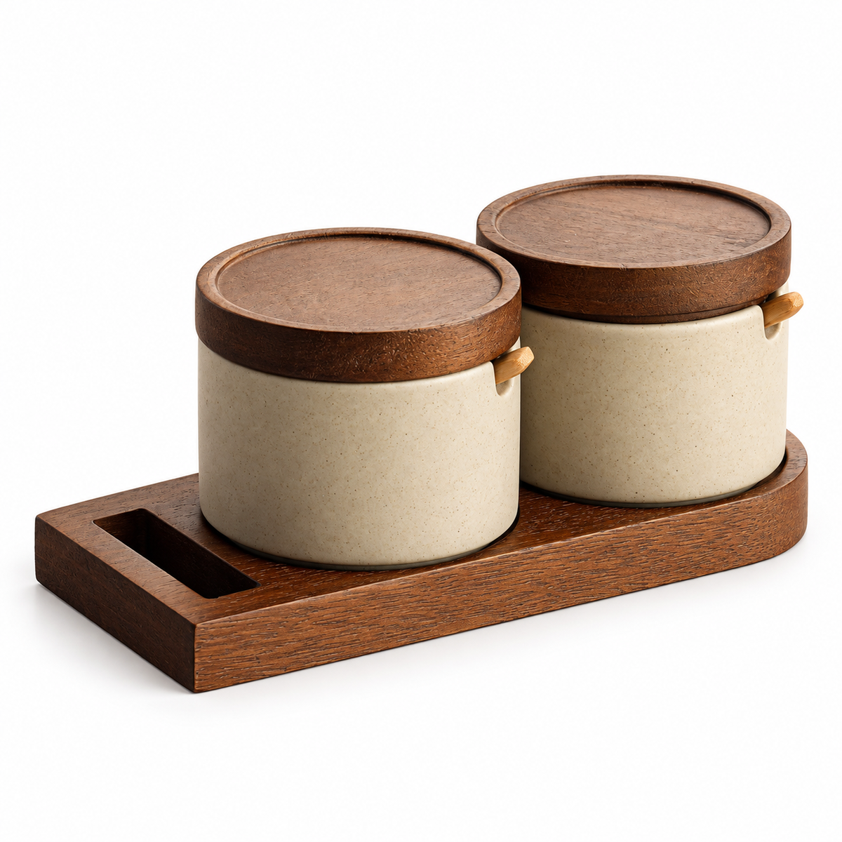 Two ceramic seasoning jars with wooden lids spoons and tray on white background