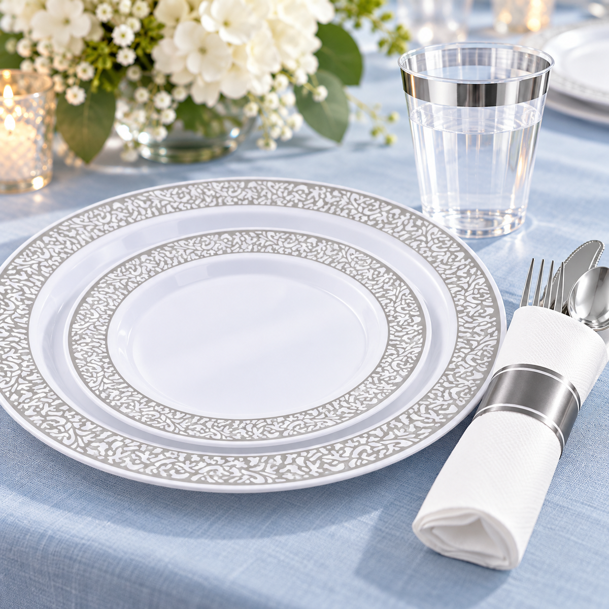 Silver Plastic Dinnerware Set for 50, 350 pc in a styled product photograph. Dinner plates, food, flowers and extra decor are styling props, not included.