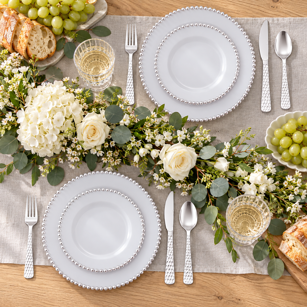 Overhead view of silver pearl-edge party dinnerware. Food, glassware and extra decor are styling props, not included.
