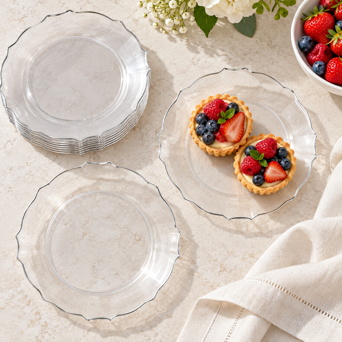 Overhead view of clear silver-rimmed petal plates at a buffet. Food, tableware and extra decor are styling props, not included.
