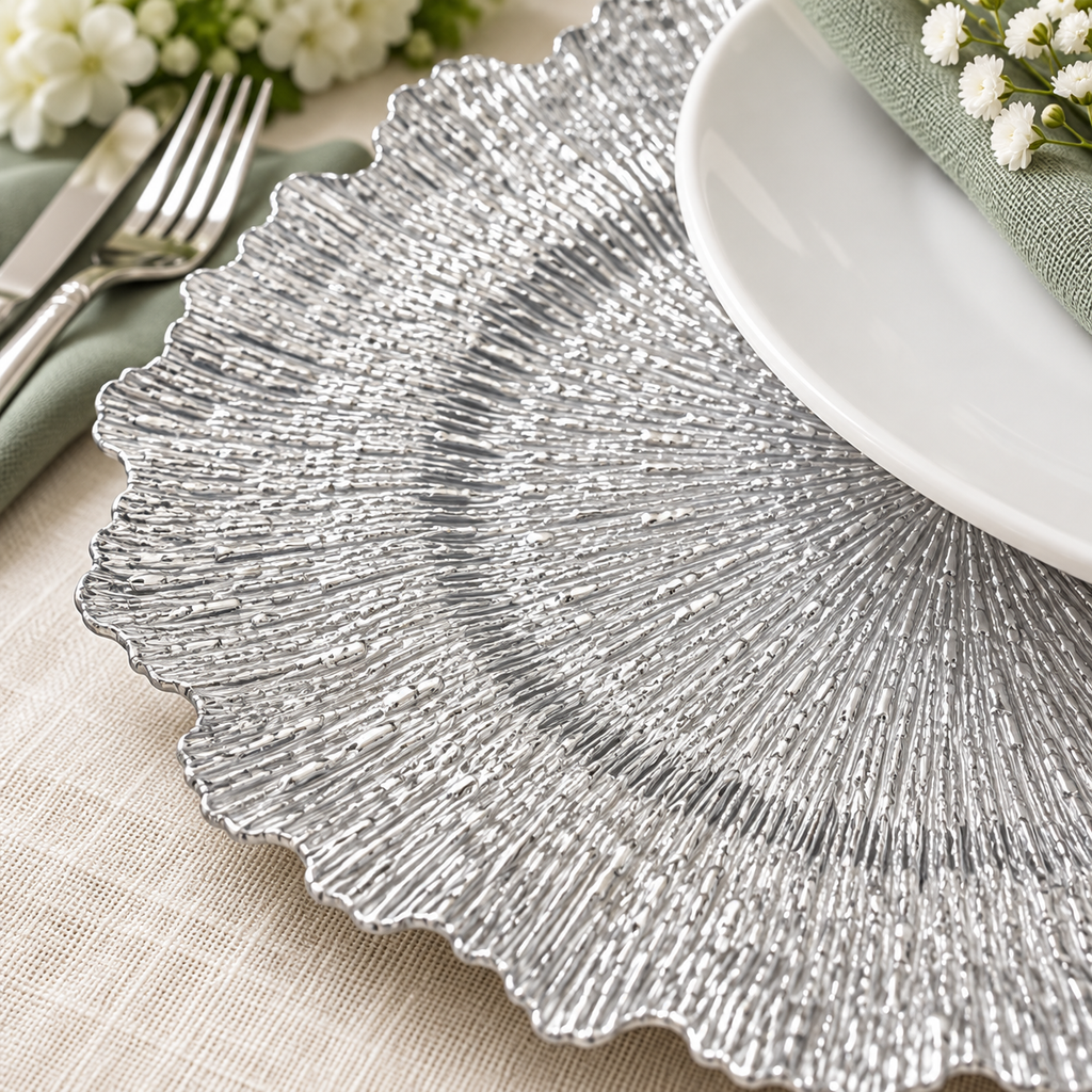 Silver Ruffled Charger Plates, 100 pc in a styled product photograph. Dinner plates, food, flowers and extra decor are styling props, not included.
