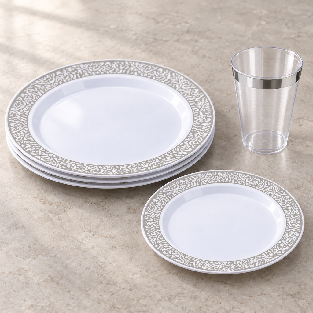 White plates with silver ornamental borders and a clear silver-rimmed cup. Empty angled arrangement showing shallow plate profiles, not the full pack quantity.