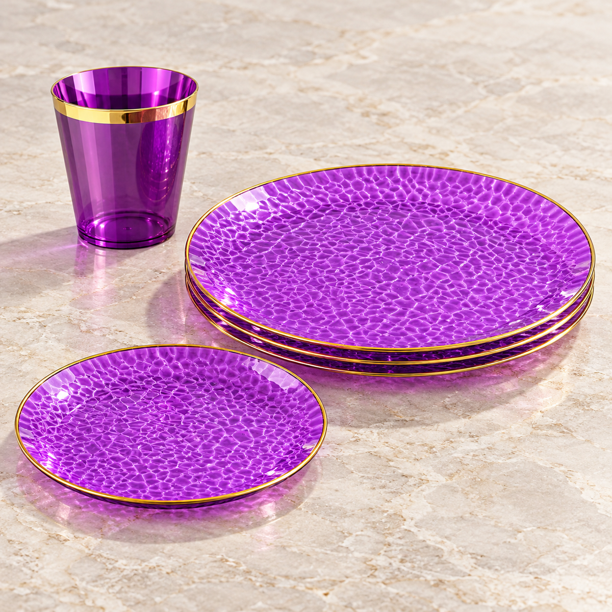 Purple hammered plates with thin gold rims and matching cup. Empty angled product view. Representative arrangement, not the full pack quantity.