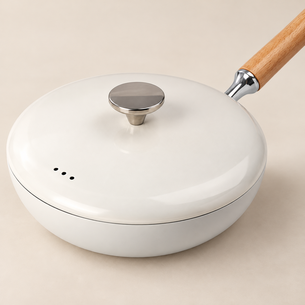 Detail of the white frying pan lid, three vents, silver knob and wood handle