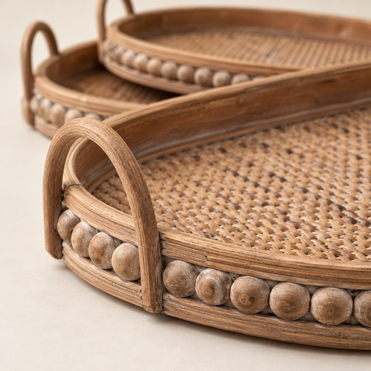 Close detail of woven rattan base, loop handle and beaded tray rim