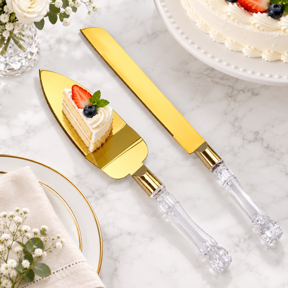 Gold-tone cake server lying flat with a small cake portion and matching knife nearby. Cake and table accessories are styling props, not included.