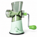 Green manual kitchen grinder with clear hopper and hand crank — hero