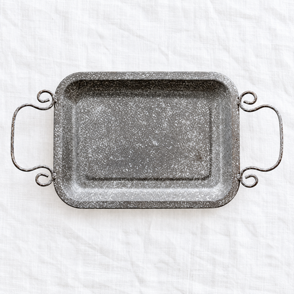Grey textured iron tray with two curled handles; scene props and serving plates not included