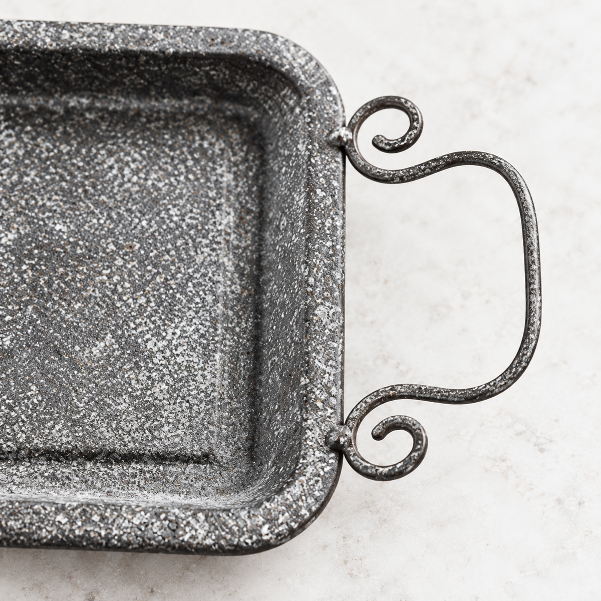 Grey textured iron tray with two curled handles; scene props and serving plates not included