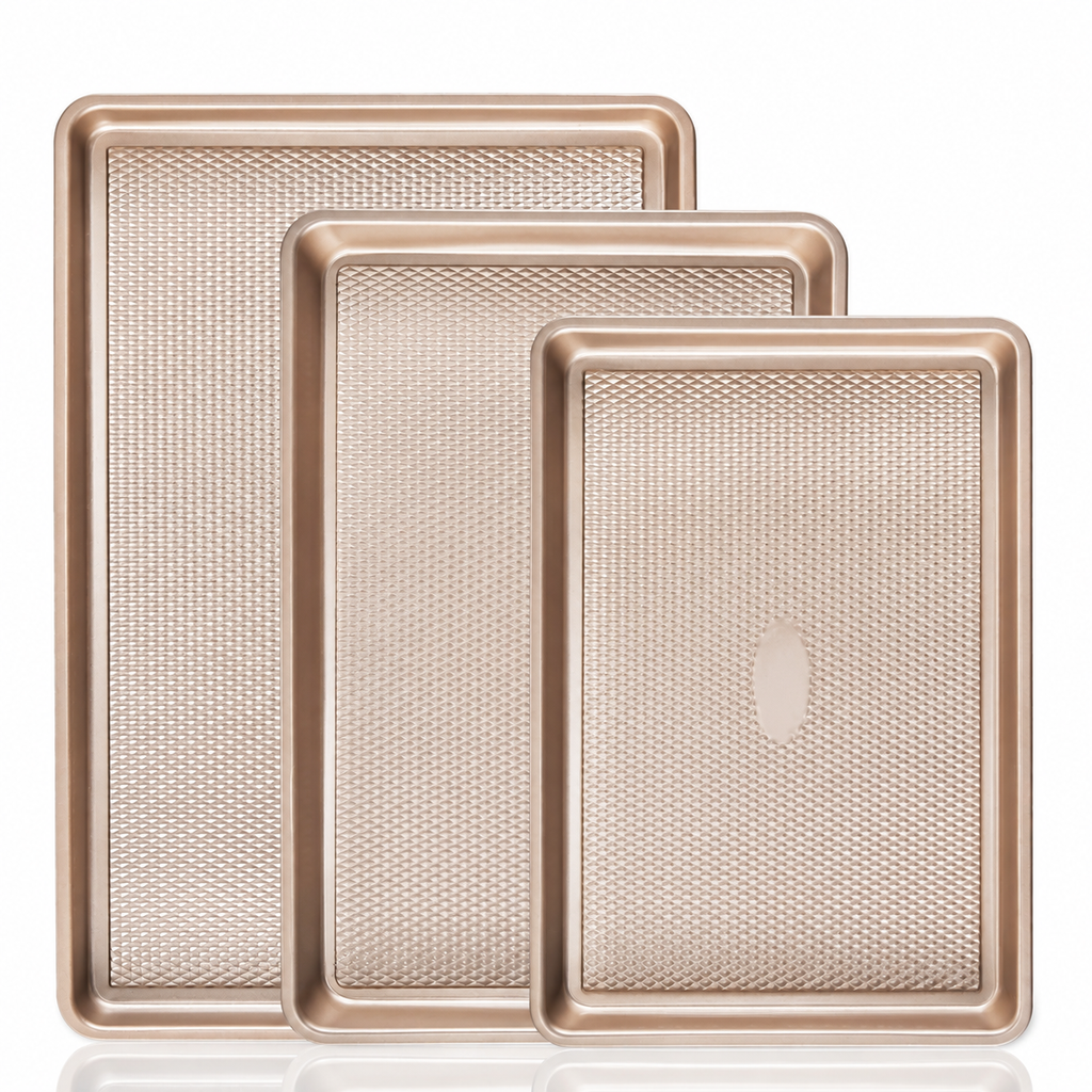 Gold three-piece baking pan set on white