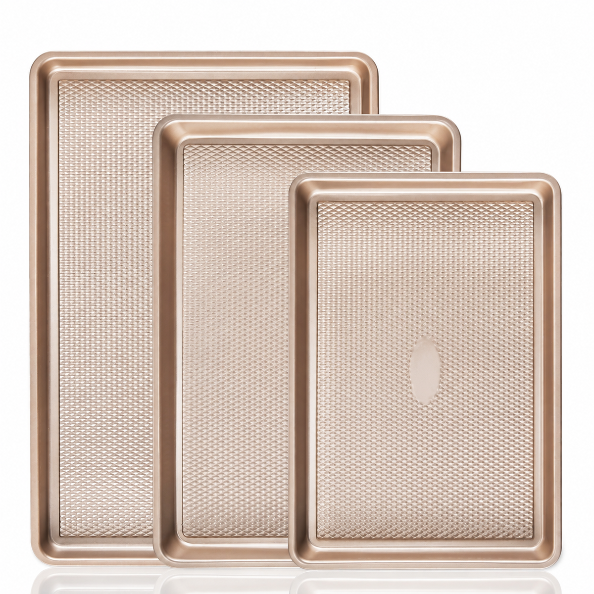 Gold three-piece baking pan set on white