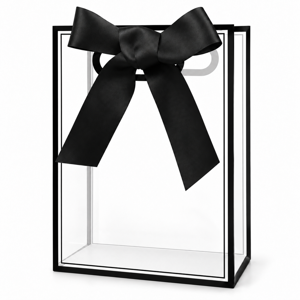 Clear black-edged gift bag with die-cut handles, black bow and pale base liner on white