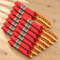 Representative red napkin rolls with gold-colored plastic cutlery and taupe bands with white stripes on a table