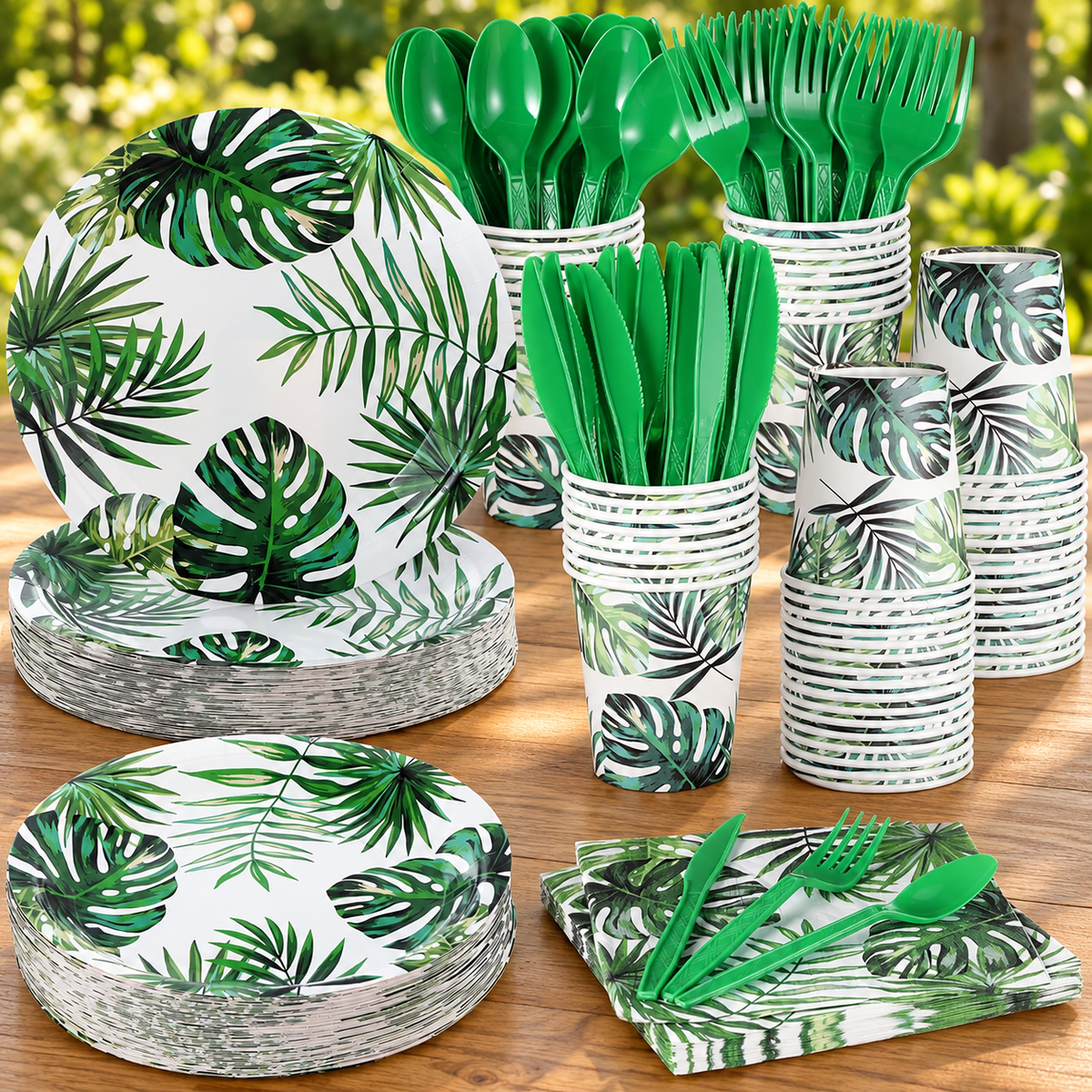 Tropical Leaf Party Tableware Set, 350 Pieces displayed on a wooden table in a natural setting