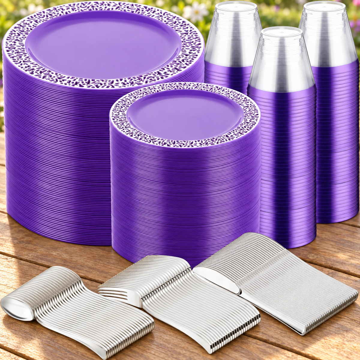 Purple and silver-colored disposable dinnerware and cutlery arranged on a table