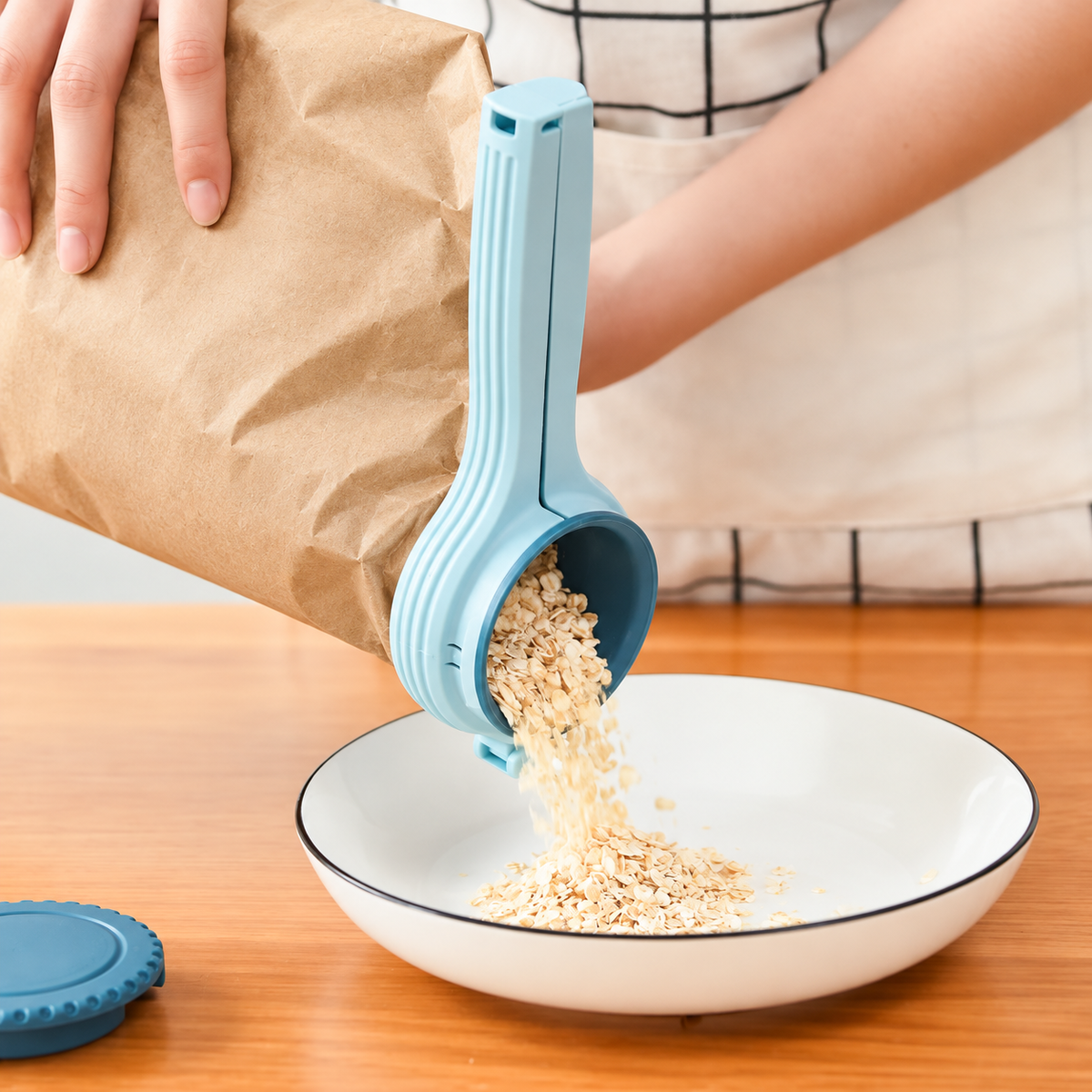 Blue sealing spout pouring oats into a bowl