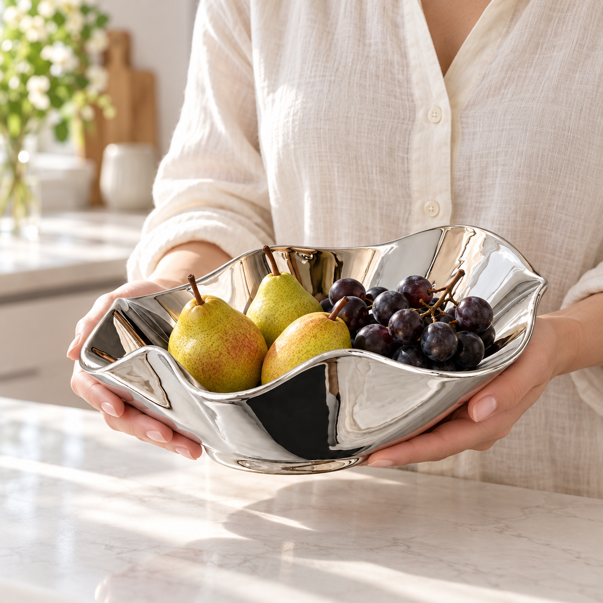 Balza silver ceramic bowl held with pears and grapes; food and styling accessories not included