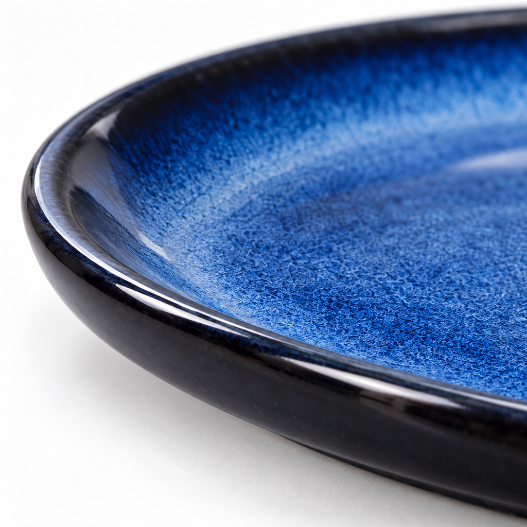 Blue gradient porcelain plate, glaze and rounded rim closeup