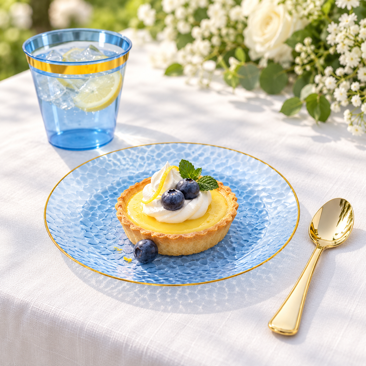 Blue gold-rim dessert plate and cup styled with a tart and drink; food and decor not included.