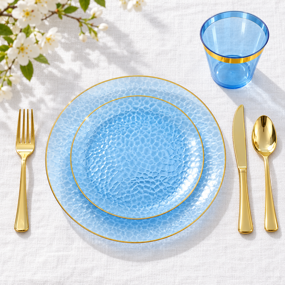 Overhead view of selected blue and gold plates, cup and cutlery; napkin not shown.