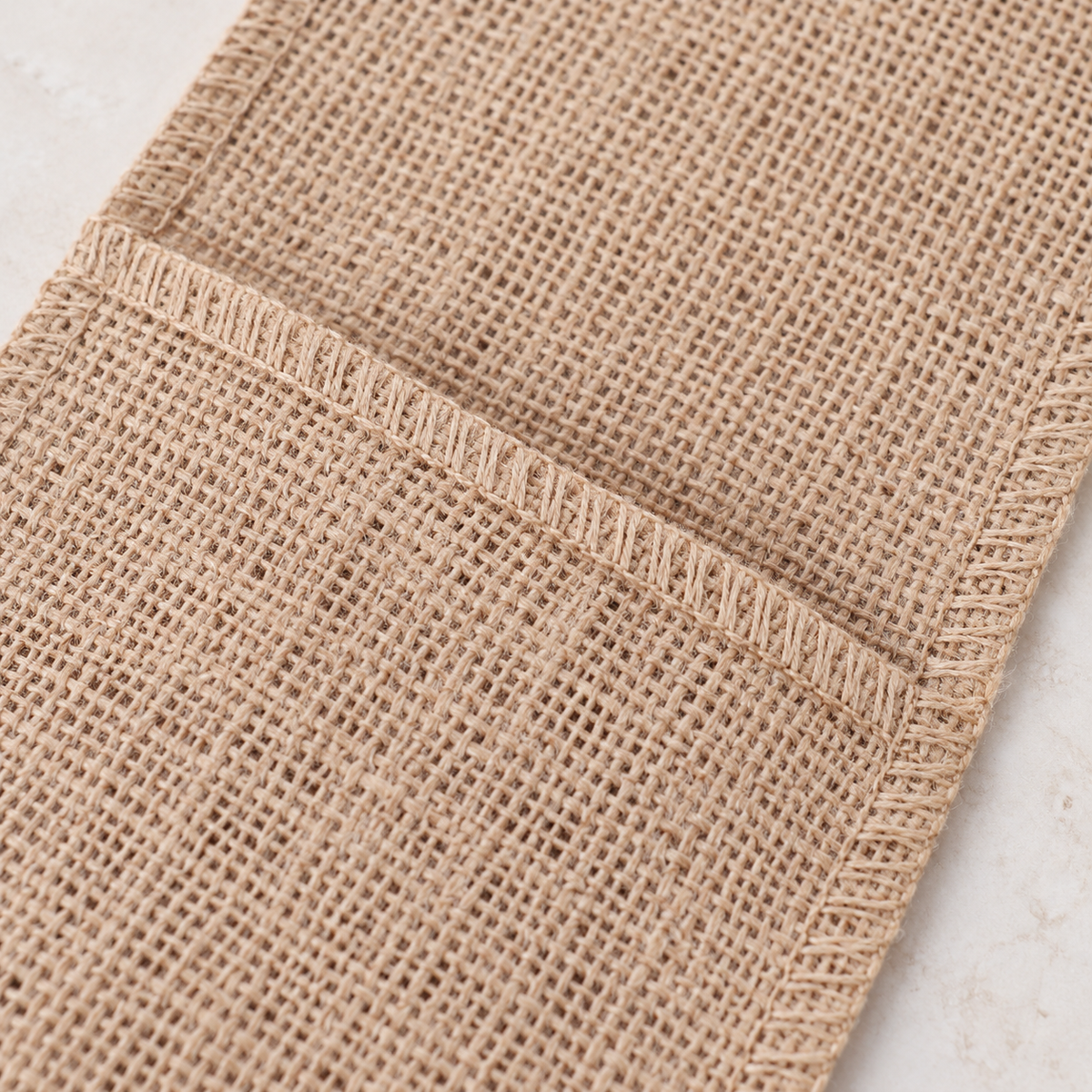 Close-up of the plain Style C pouch's coarse woven texture.