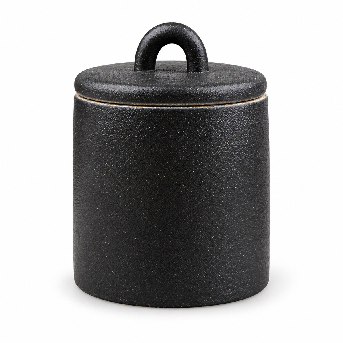Black ceramic tea canister on white