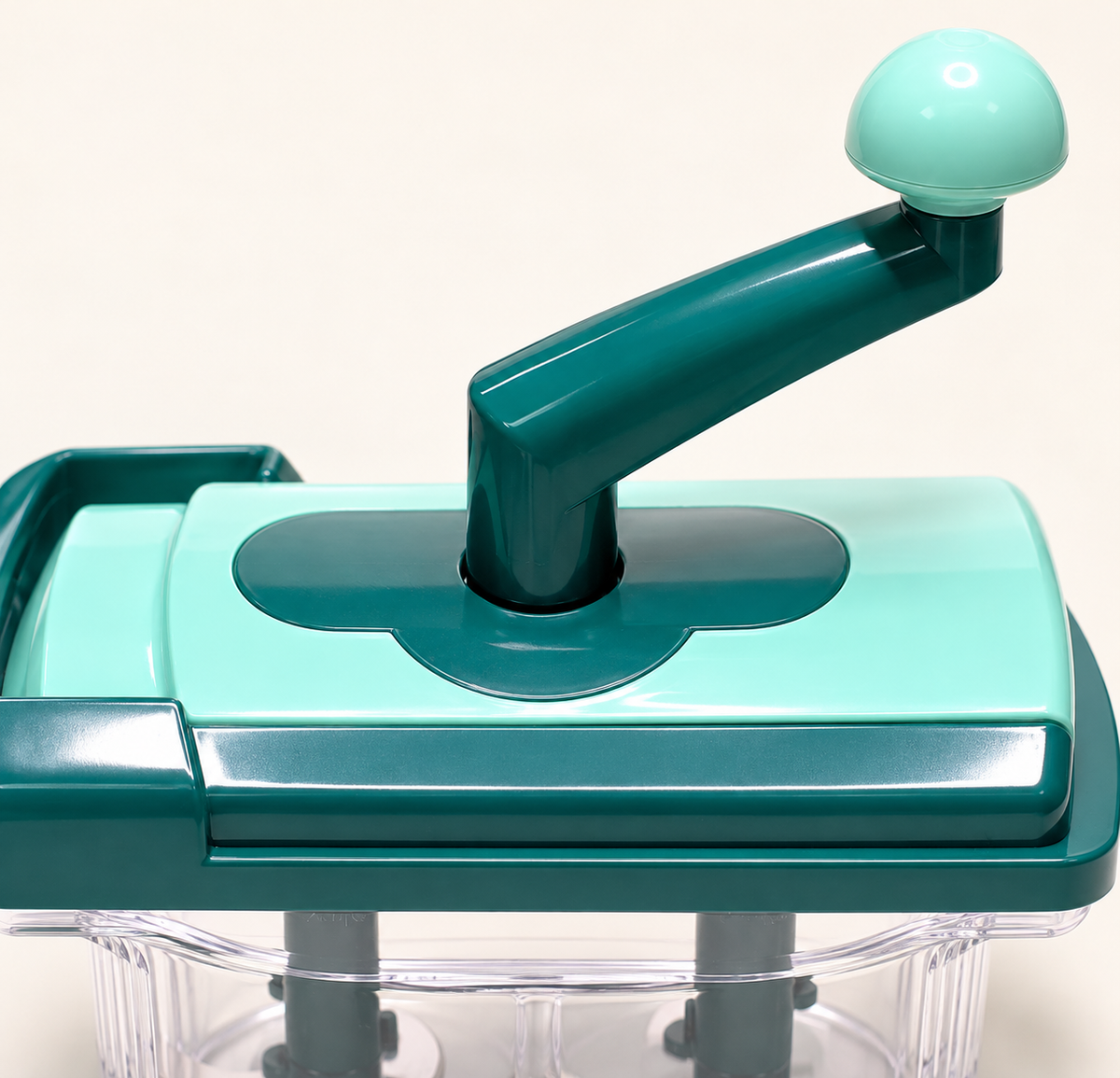 Green hand-crank vegetable chopper, crank detail
