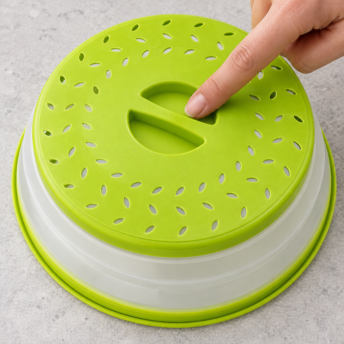Close view of the green cover recessed grip and leaf-shaped vents with a fingertip showing grip access