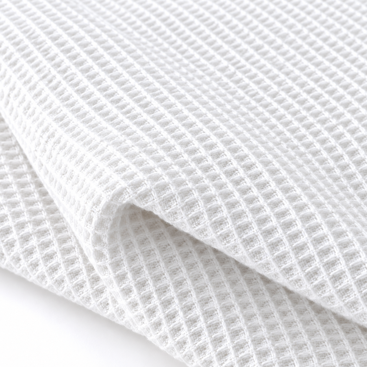 Off-white honeycomb weave and fringe textile detail.