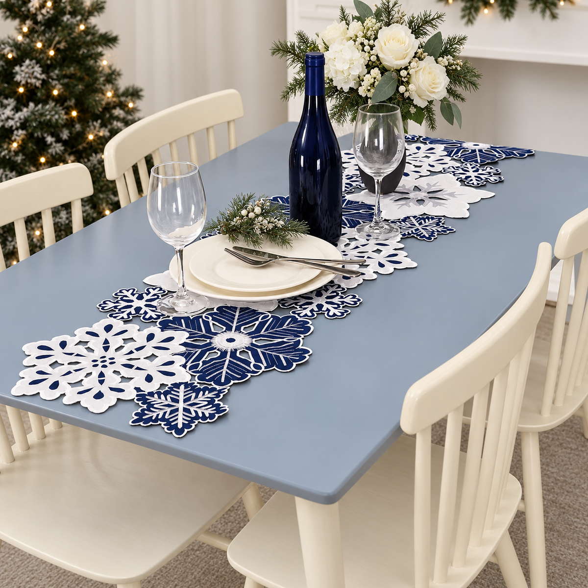 Navy and white snowflake table runner styled on a pale blue-grey dining table; tableware and decorations not included