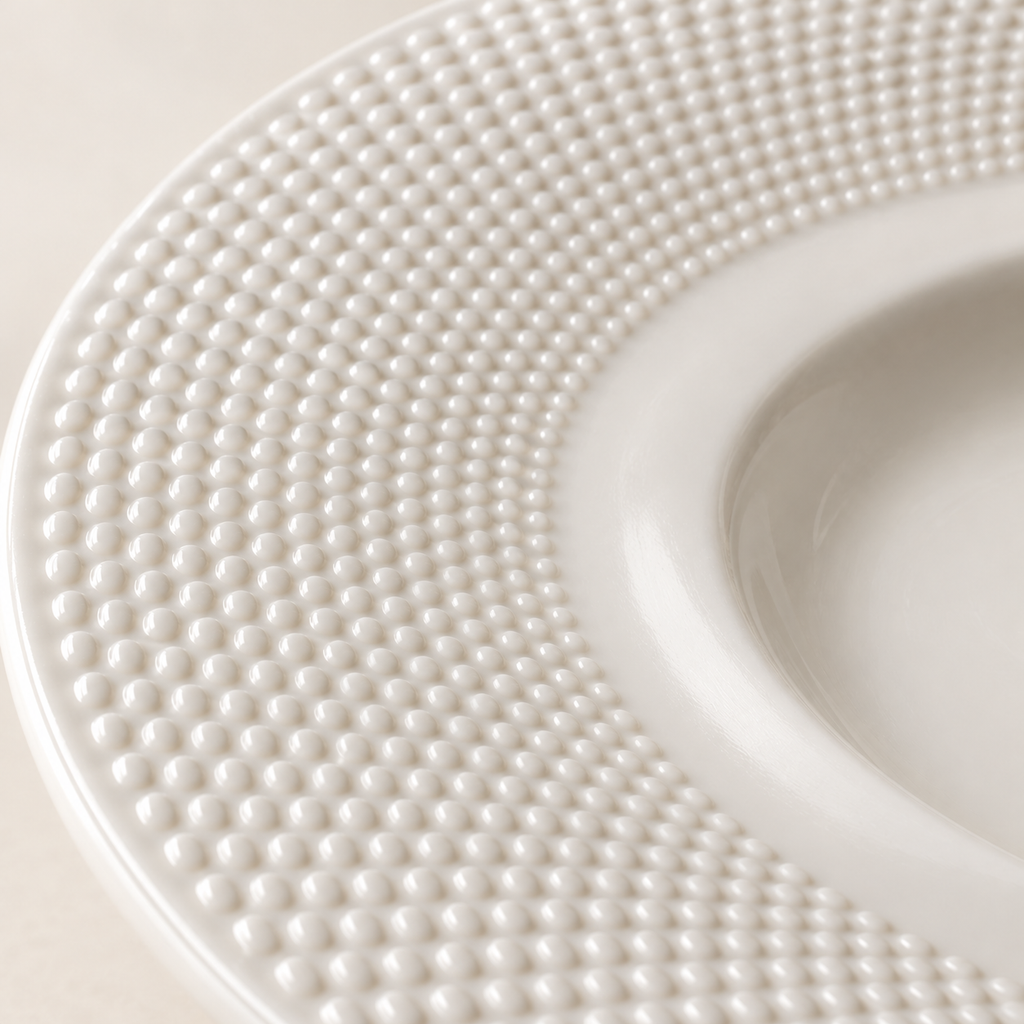 Macro of fine raised bead texture on ceramic plate rim
