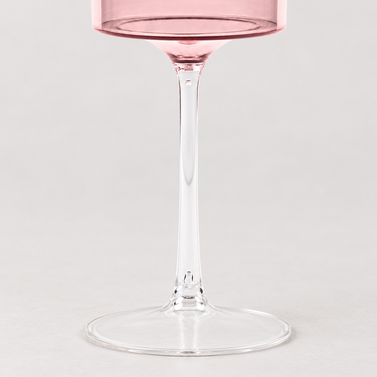 Detail of the clear goblet stem, bowl connection and round base.