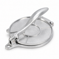 Silver aluminum tortilla press with closed round plates and lever handle on white
