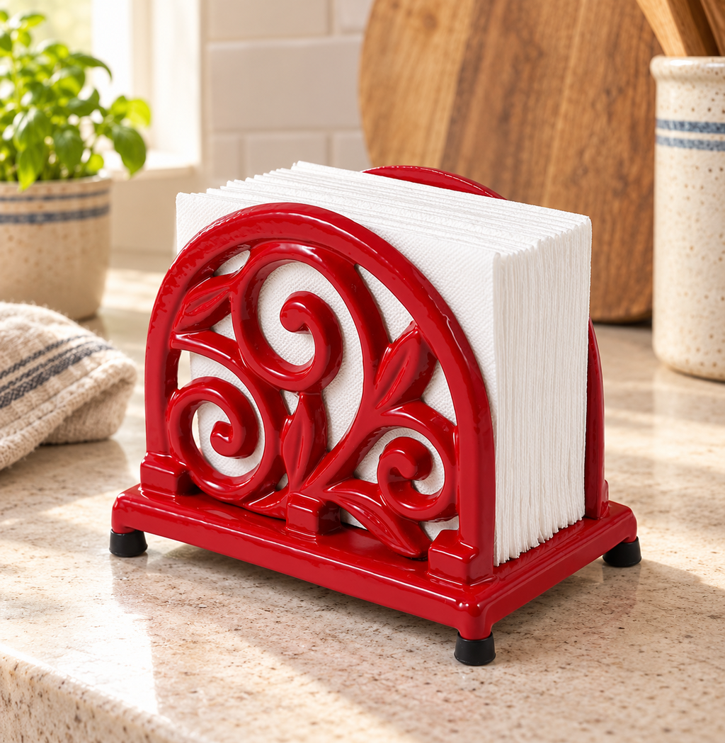 Red scrollwork cast iron napkin holder — kitchen setting; napkins and props not included