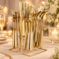 Regal gold 24-piece cutlery with textured handles on its wire stand, styled on ivory linen; decorative props not included.