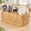 Woven utensil caddy staged with cutlery, napkins and plates; contents not included