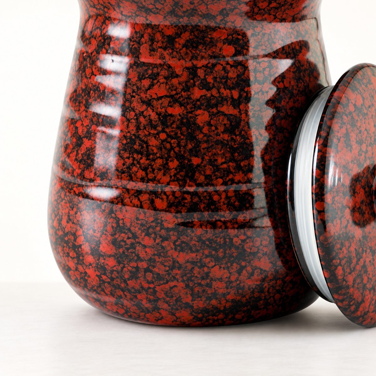Red-black glaze and rounded lower jar profile