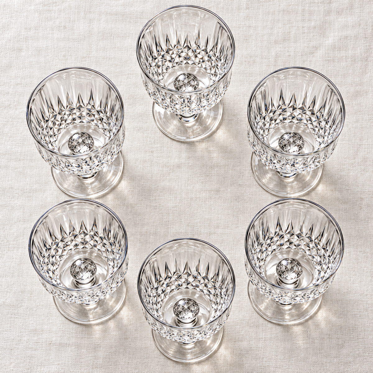 Overhead view of the complete set of six empty diamond-cut goblets
