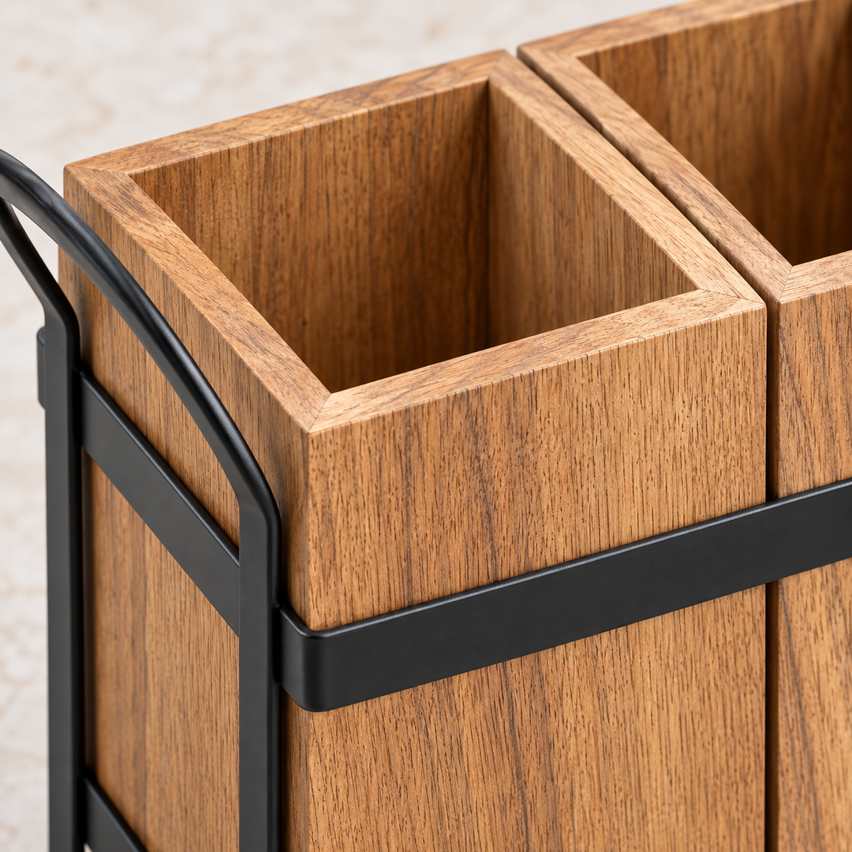 Close view of acacia wood grain, compartment divider and black metal frame junction
